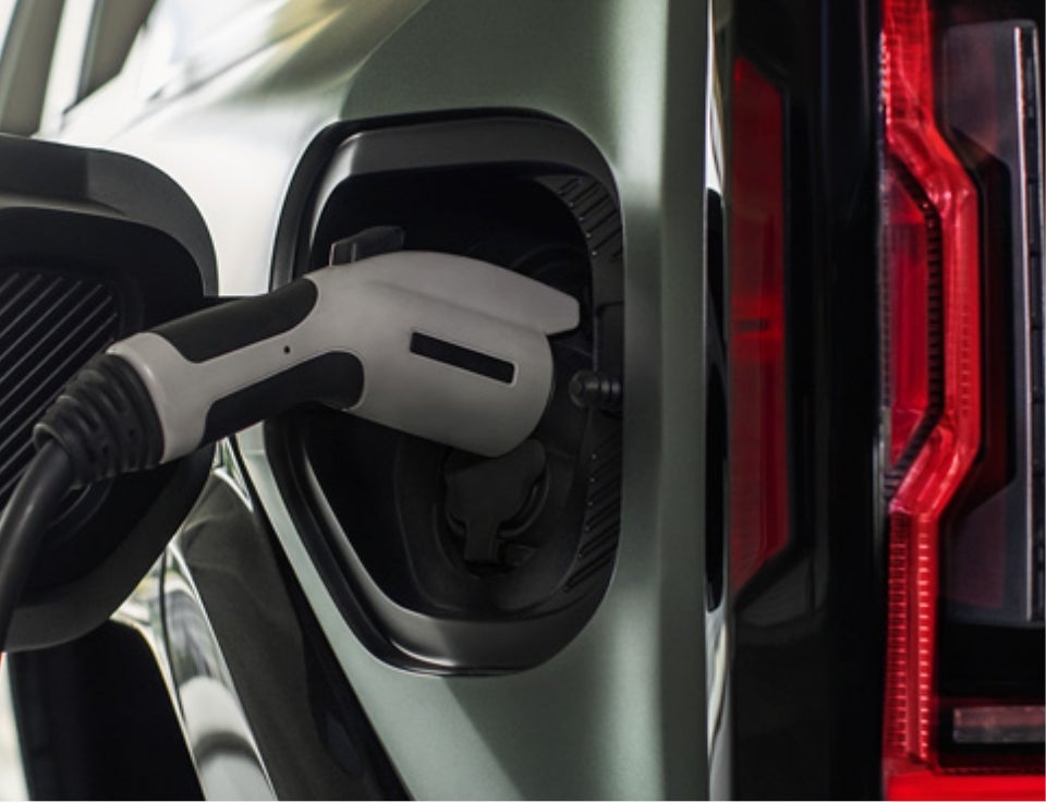 Close up of charging port with charger plugged in on a GMC Hummer EV SUV - Lighthouse Buick GMC in Morton IL
